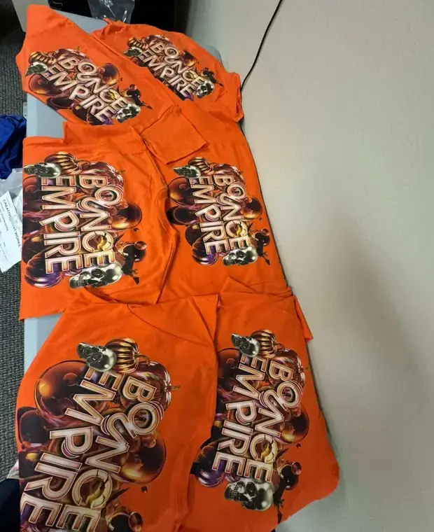 A batch of orange T-shirts with matching printed designs
