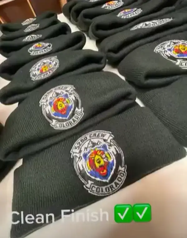 Crest-embroidered beanies arranged together